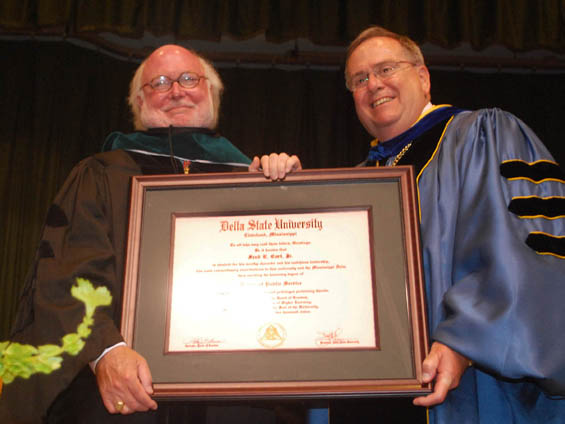 Delta State University President Dr. John M. Hilpert (right) presents Fred Carl, Jr. with an Honorary Doctor of Science degree during Spring Commencement exercises.